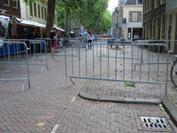 850267 Gezicht in de Breedstraat te Utrecht, met verschillende hekken die het publiek op de lapjesmarkt op afstand van ...